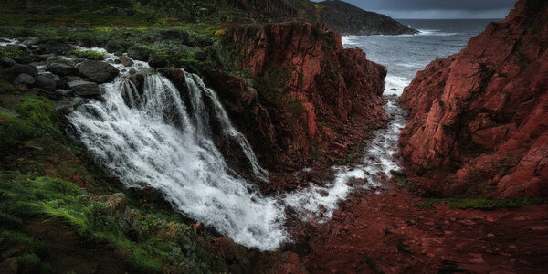 Tundra nature colorful landscape at Kola Peninsula in the autumn. Waterfall near Teriberka village at Murmansk Region in Northern Russia