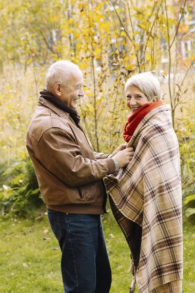 Portrait of a nice old couple at nature Happy nice senior couple in autumn forest