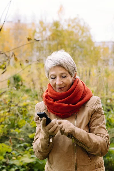 Portrait of a woman over 50 with mobile phone