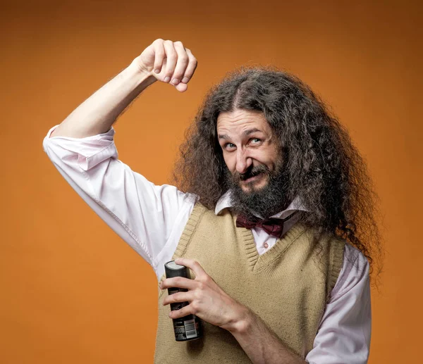 Freaky nerd using a fragrant deodorant — Stock Photo, Image