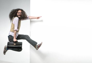 Beyaz, boş tahtanın yanında zıplayan bir ineğin portresi.