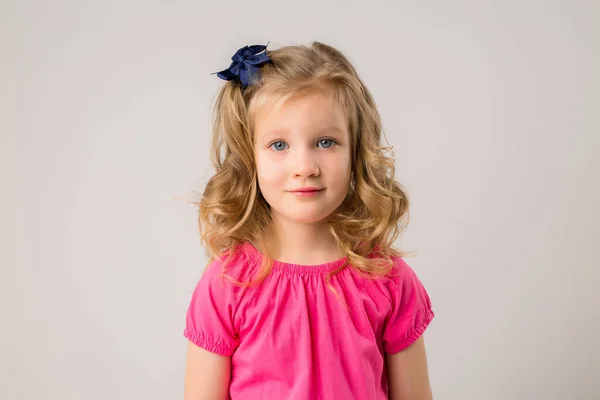 Retrato Uma Menina Loira Com Cachos Uma Camiseta Rosa Fundo — Fotografia de Stock