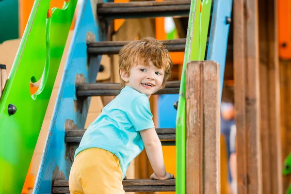Χαρούμενη Κοκκινομάλλα Αγόρι Παίζει Πολύχρωμο Διαφάνεια Και Αναρρίχηση Πύργος Παιδική — Φωτογραφία Αρχείου