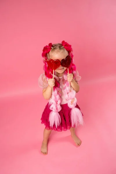 Niña Feliz Con Grandes Trenzas Rosadas Divirtiéndose Con Piruletas Forma —  Fotos de Stock