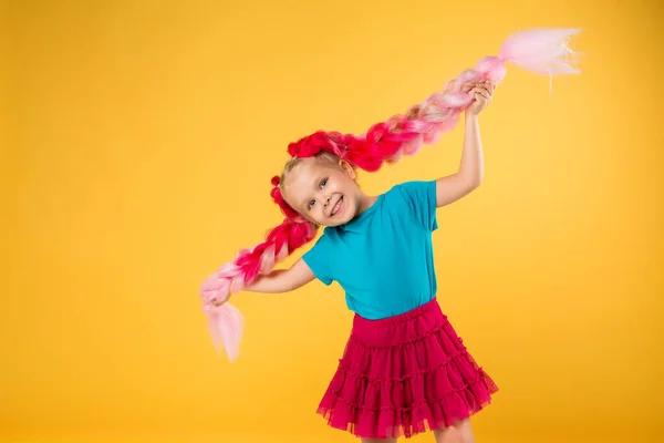 Happy Girl Big Pink Braids Having Fun Orange Background Children — стоковое фото