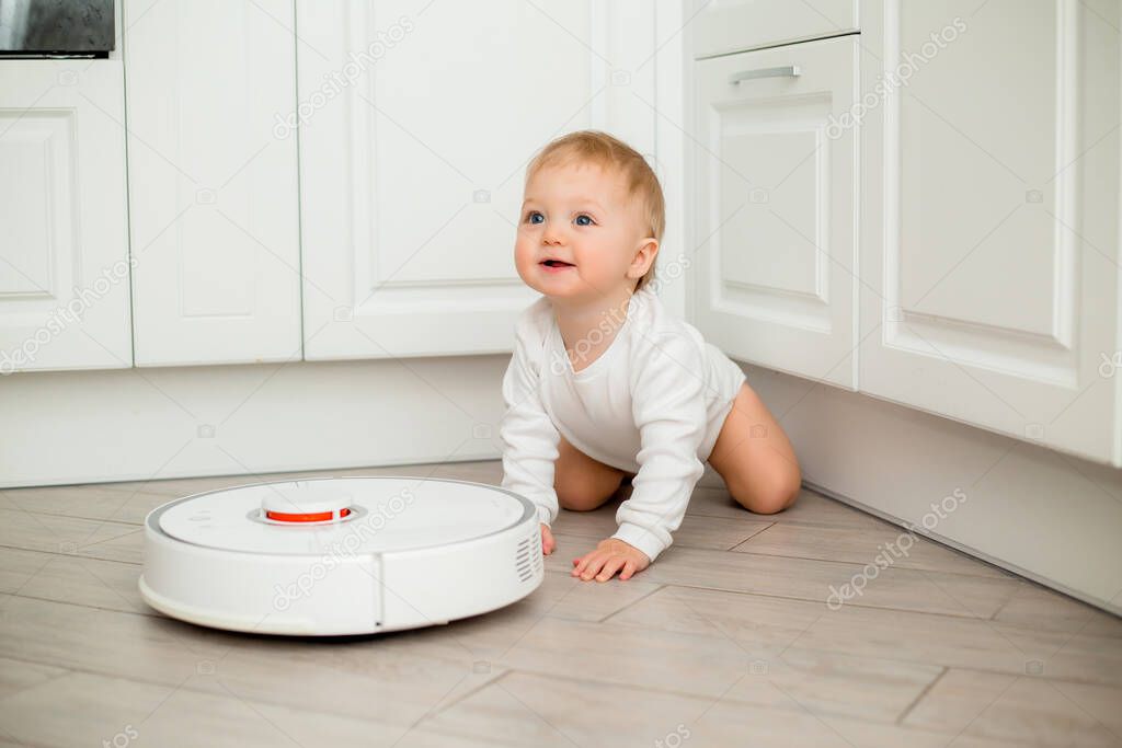 little cute baby and robotic vacuum
