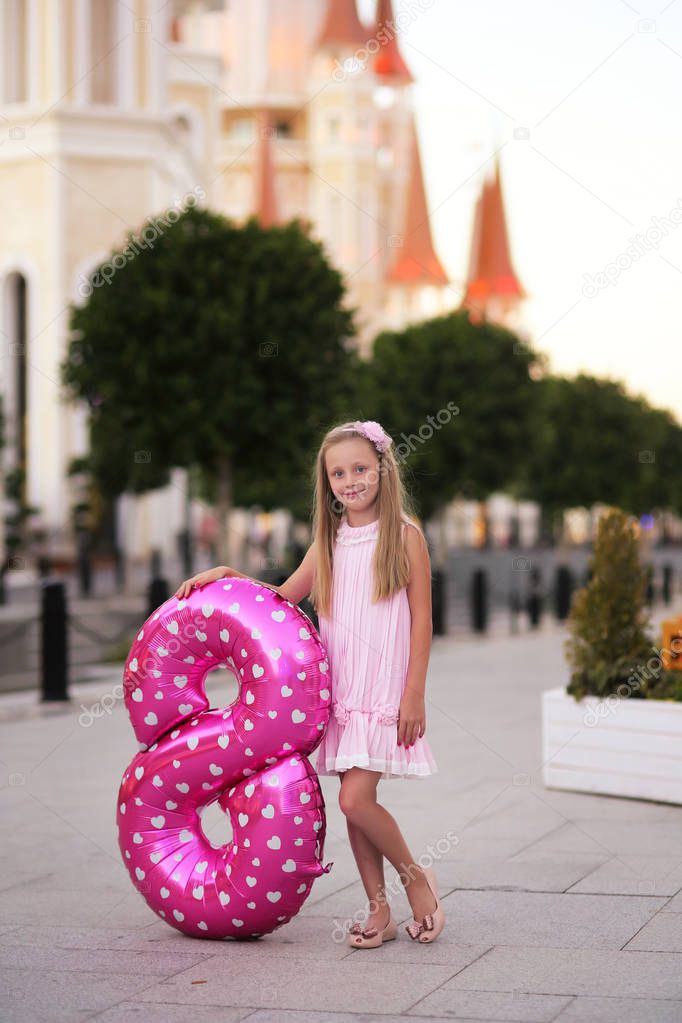 Children's birthday. Smiling a beautiful blond little girl with 