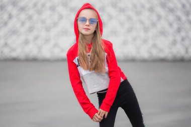 Dans için takım elbiseli kapüşonlu bir kızın portresi. Sokakta hip hop dansı yaptığı kız. Genç kentsel hip hop dansçısı
