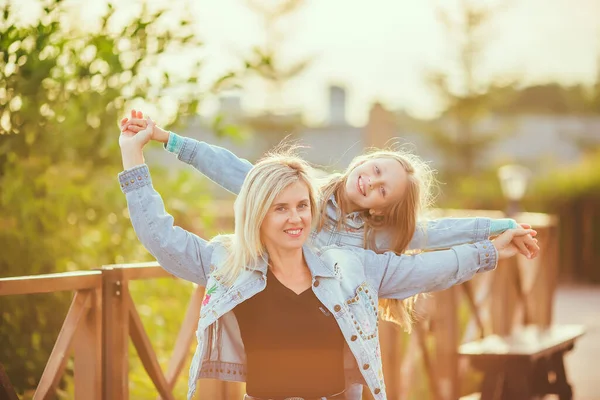 Happy mother and daughter 8-9 years old walk in the Park in the summer, the concept of a happy family, the relationship of mother and child, mother\'s day