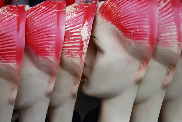 plastic mannequins with red hairs lined up