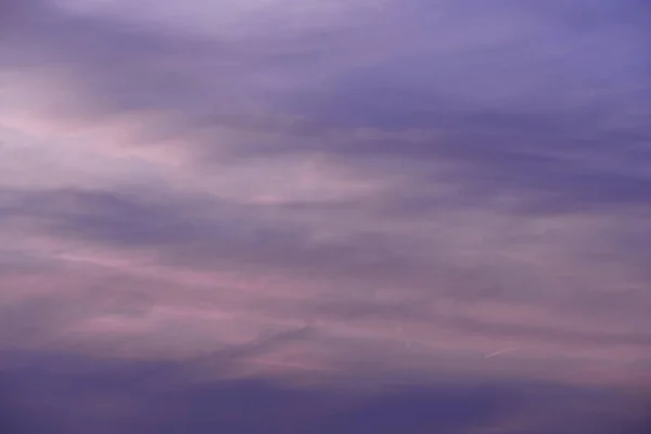 Pink-violet evening sky with thin clouds