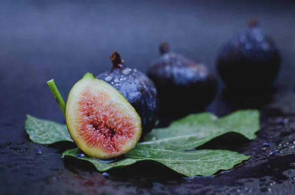 Fresh figs on a dark background on a table. Flat lay. Top view.