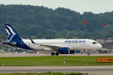 Zürih, İsviçre, 5 Ağustos 2025 SX-NEV Aegean Airbus A320-271N uçağı kapıya yanaşıyor.