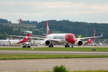 Zürih, İsviçre, 5 Ağustos 2025 HB-IHF Edelweiss Air Airbus A350-941 uçağı kapıya yanaşıyor.