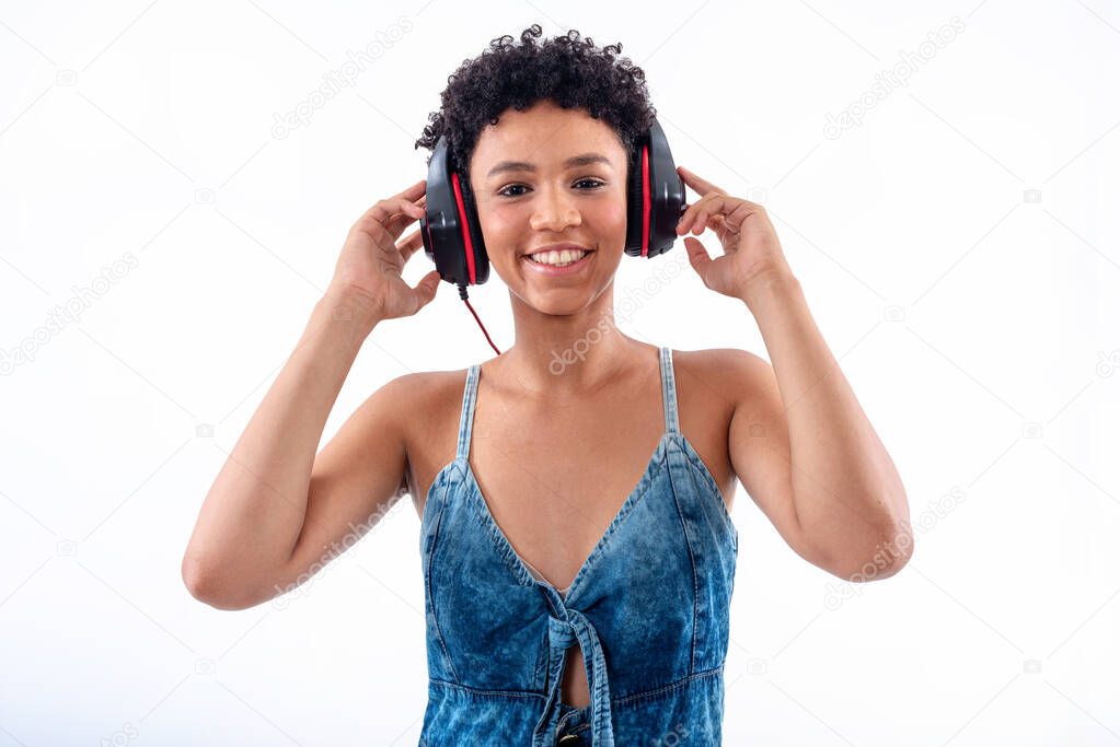 Studio photography of elegant young woman smiling with headphone against white background. Beautiful female model with headset on white background.