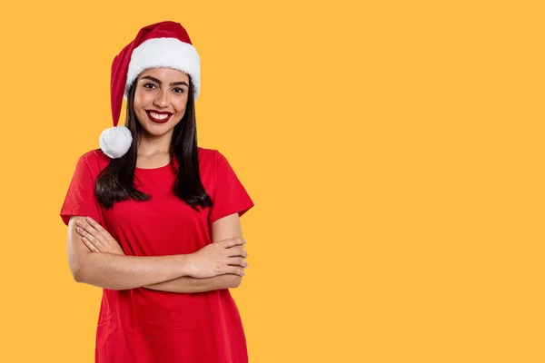 Woman with Christmas hat, isolated on yellow background.