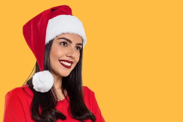 黄色の背景に隔離されたクリスマスの帽子を持つ女性 — ストック写真