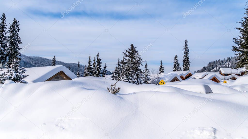 Deep snow pack covering houses and roads of the alpine village of Sun Peaks in the Shuswap Highlands of central British Columbia, Canada