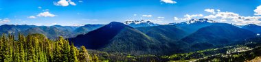 Panorama view of the Rugged Peaks of the Cascade Mountain Range on the US-Canada border as seen from the Cascade Lookout viewpoint in EC Manning Provincial Park in British Columbia, Canada clipart