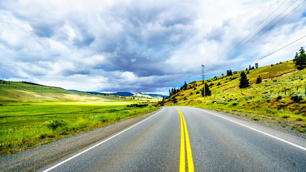 Dark Clouds hanging over the fertile farmland and rolling hills along Highway 5A near Nicola Lake, between Kamloops and Merritt in the Okanagen region of British Columbia, Canada