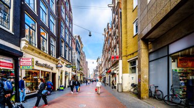 Amsterdam, Noord Holland/the Netherlands - Oct. 3 2018: The Nieuwendijk, a famous shopping street in the center of the old city of Amsterdam clipart