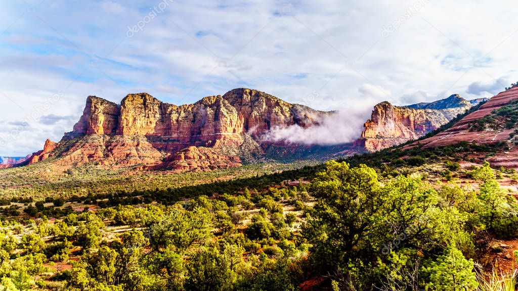 Clouds hanging around the Red Rocks of the Munds Mountain  Range near the town of Sedona in northern Arizona in Coconino National Forest, USA