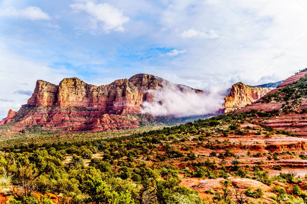Clouds hanging around the Red Rocks of the Munds Mountain  Range near the town of Sedona in northern Arizona in Coconino National Forest, USA