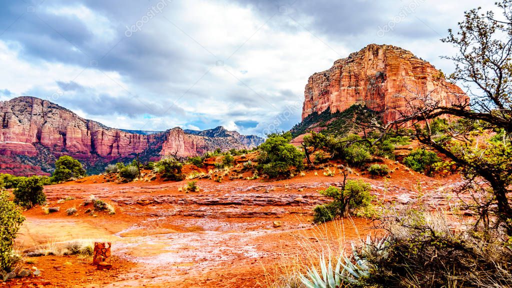 After rain showers, streams and puddles forming at Courthouse Butte, a famous red rock between the Village of Oak Creek and Sedona in northern Arizona's Coconino National Forest, USA