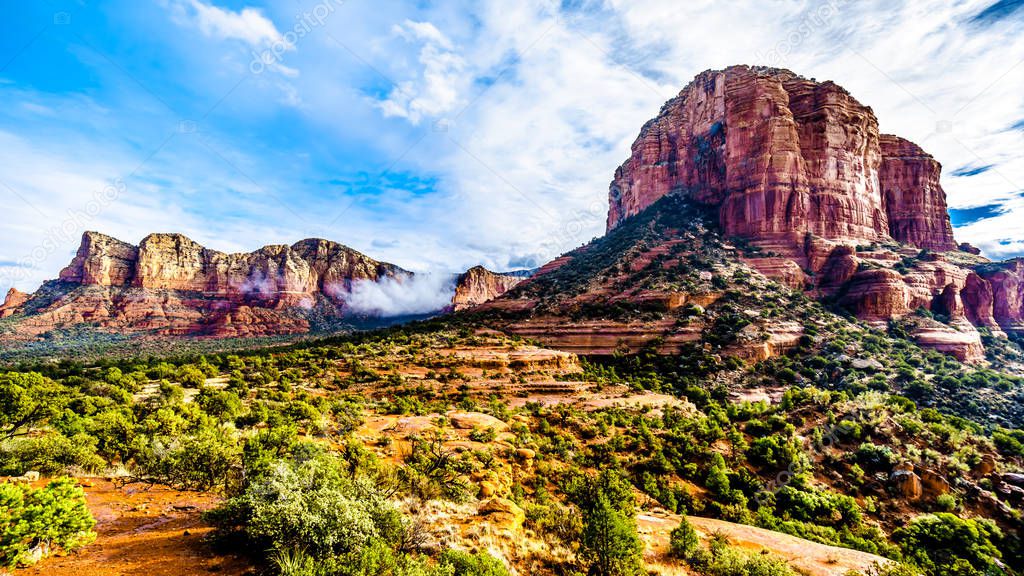 Clouds hanging around Lee Mountain and Courthouse Butte between the Village of Oak Creek and Sedona in northern Arizona in Coconino National Forest, United States of America