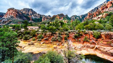The colorful sandstone mountains and canyon carved by Oak Creek at famous Slide Rock State Park along Arizona SR89A between Sedona and Flagstaff in northern Arizona, United States of America clipart