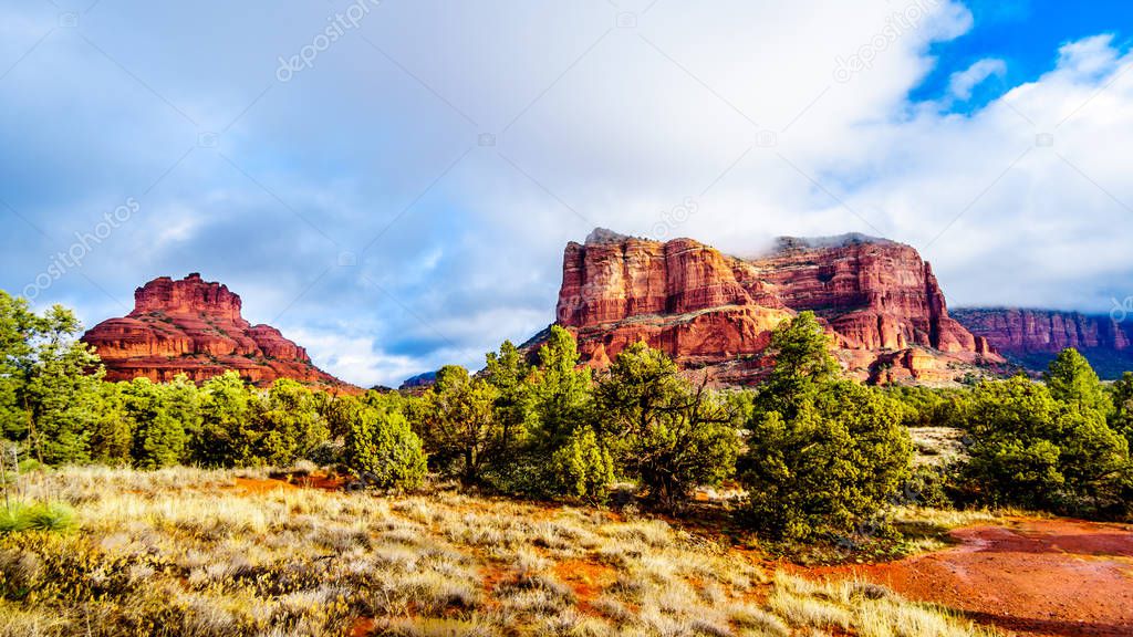 Clouds and blue sky over Bell Rock and Courthouse Butte between the Village of Oak Creek and the town of Sedona in northern Arizona in Coconino National Forest, United States of America