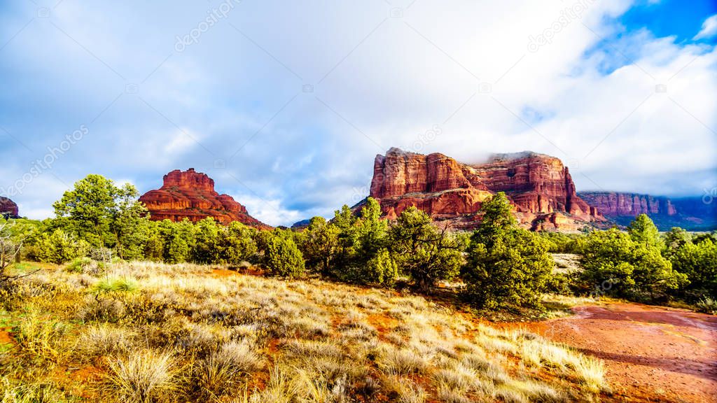 Clouds and blue sky over Bell Rock and Courthouse Butte between the Village of Oak Creek and the town of Sedona in northern Arizona in Coconino National Forest, United States of America