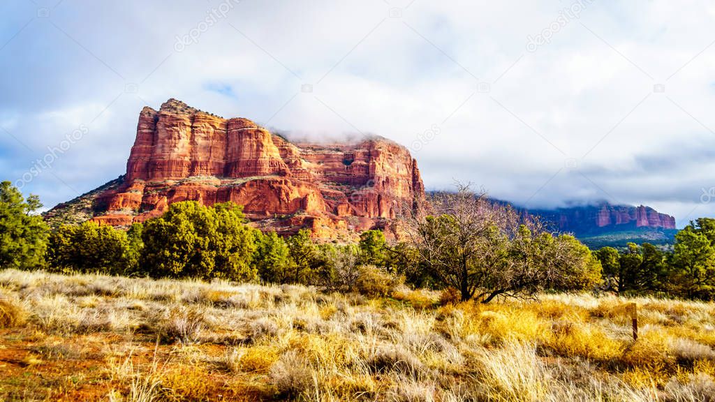Clouds and blue sky over Courthouse Butte between the Village of Oak Creek and the town of Sedona in northern Arizona in Coconino National Forest, United States of America