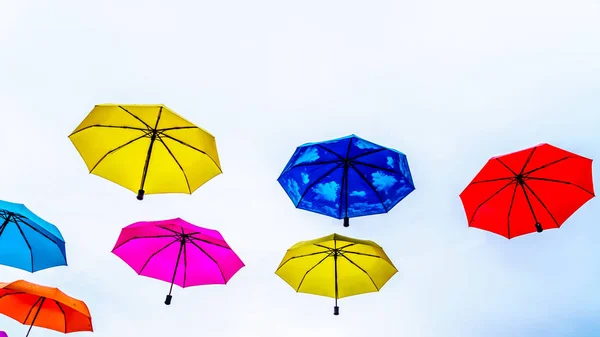 Colorful Umbrellas floating in the air under cloudy sky — Stock Image Colorful Umbrellas Floating Air Cloudy Sky Stock Image
