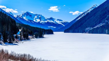 Frozen Duffey Lake and the snow capped peaks around  lake. Mount Rohr at the south end of the lake along Highway 99 between Pemberton and Lillooet, British Columbia clipart