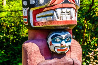 Renkli 'Thunderbird House Post Totem Pole' bir parçasının ayrıntıları bir insan tutan bir Grizzly ayı tasvir