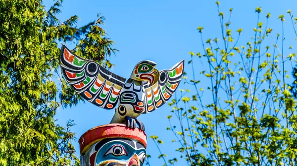 The top of the colorful \'Ga\'akstalas Totem Pole\' depicting a Quolous, a legendary bird. One of the most colorful and intricately carved totem poles at Stanley Park