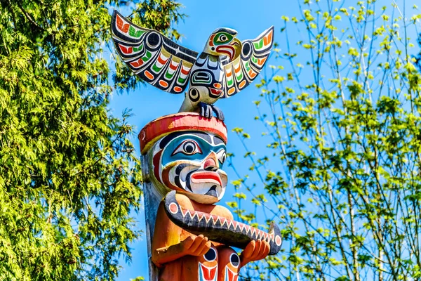 The top of the colorful \'Ga\'akstalas Totem Pole\' depicting a Quolous, a legendary bird. One of the most colorful and intricately carved totem poles at Stanley Park