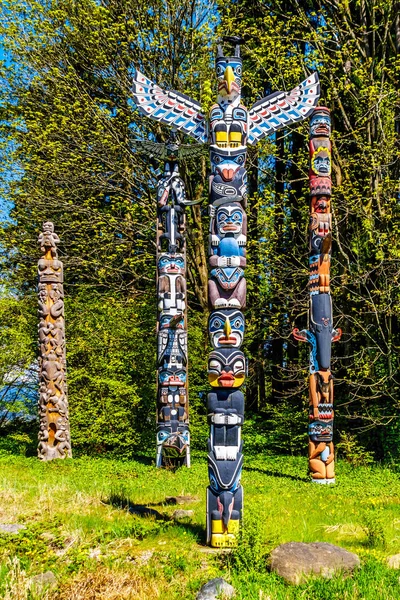 Colorful indigenous Totem Poles representing art and religious symbols of West Coast Indigenous peoples located in Stanley Park in Vancouver, Canada