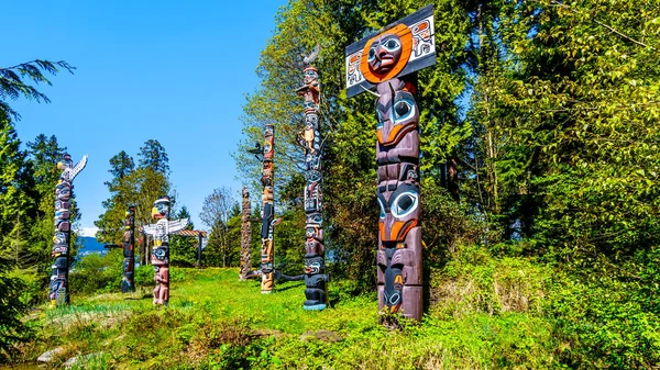 Colorful indigenous Totem Poles representing art and religious symbols of West Coast Indigenous peoples placed in Stanley Park in Vancouver, Canada