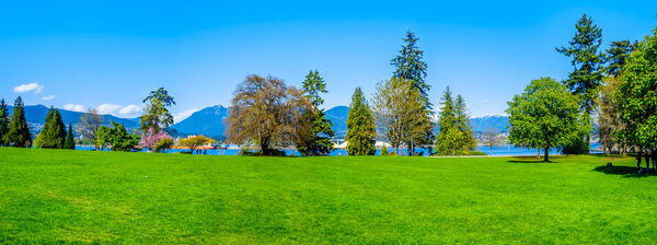 Panorama of the green lawn at Brockton Point in Vancouver's Stanley Park