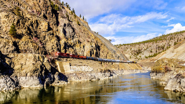 Long Freight Trains following the Thompson and Fraser Rivers along steep Cliffs and through Tunnels in the Thompson and Fraser River Canyon 