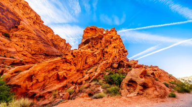 Erosion of the Red Aztec Sandstone Mountains at Sunrise at the Mouse's Tank Road in the Valley of Fire State Park in Nevada, USA clipart