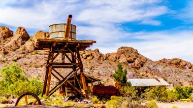 Vintage water tower and buildings, used in several old movies, are still in the old mining town of El Dorado in the Eldorado Canyon in the Nevada Desert clipart