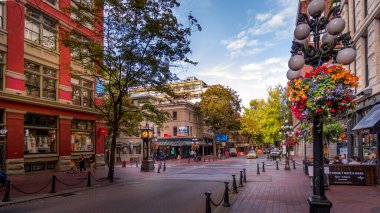 Vancouver, BC/Canada - July 16, 2020: The famous Water Street with its Steam Clock, Shops and Restaurants in the historic Gastown part of Vancouver clipart
