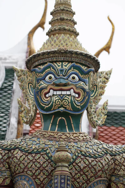 Ancient guardian giant monster god statue with scary teeth at royal template palace, signature of Thailand Travel destination backgrounds