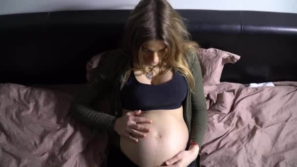 Pregnant Woman Bed Touching Her Belly — Stock Video