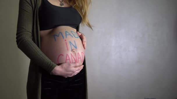 Pregnant Woman Rotates Inscription Made Canada Her Belly — Stock Video