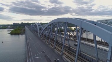 Hava videosu. Ukrayna, Kyiv 'deki modern otomobil ve eski demiryolu köprüleri.