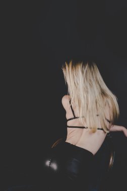 arkadan görünüşü seksi iç çamaşırlarıyla oturan şehvetli kadın